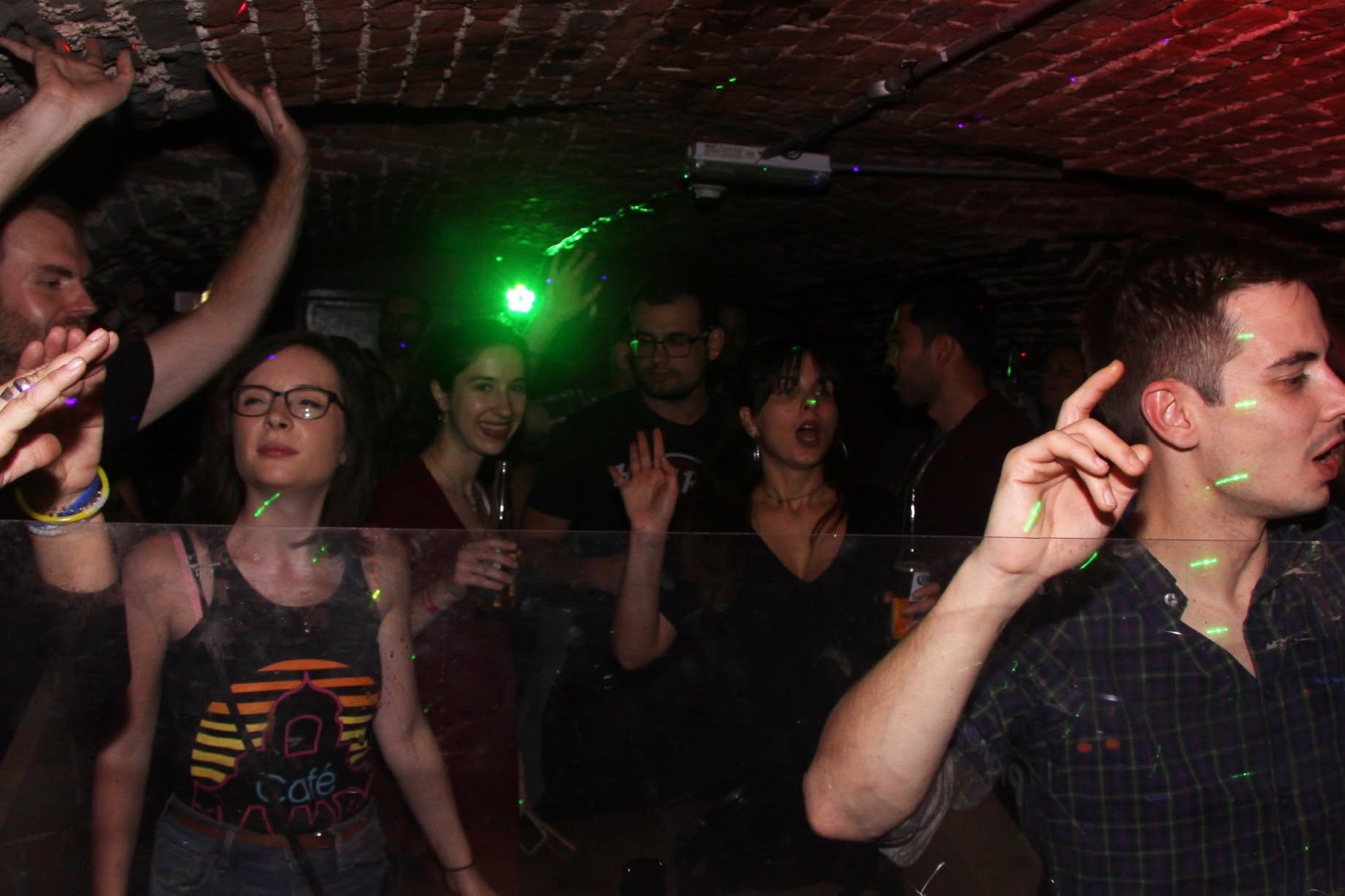 Crowd dancing under green lasers at Trancelation