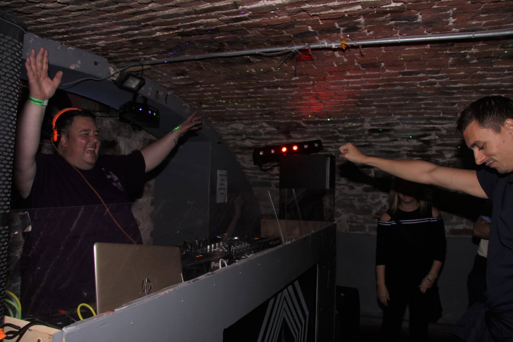 DJ with orange headphones on Pioneer decks at Trancelation
