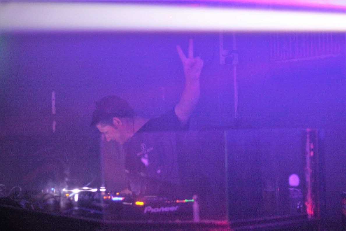 DJ on Pioneer decks under purple haze at Trancelation