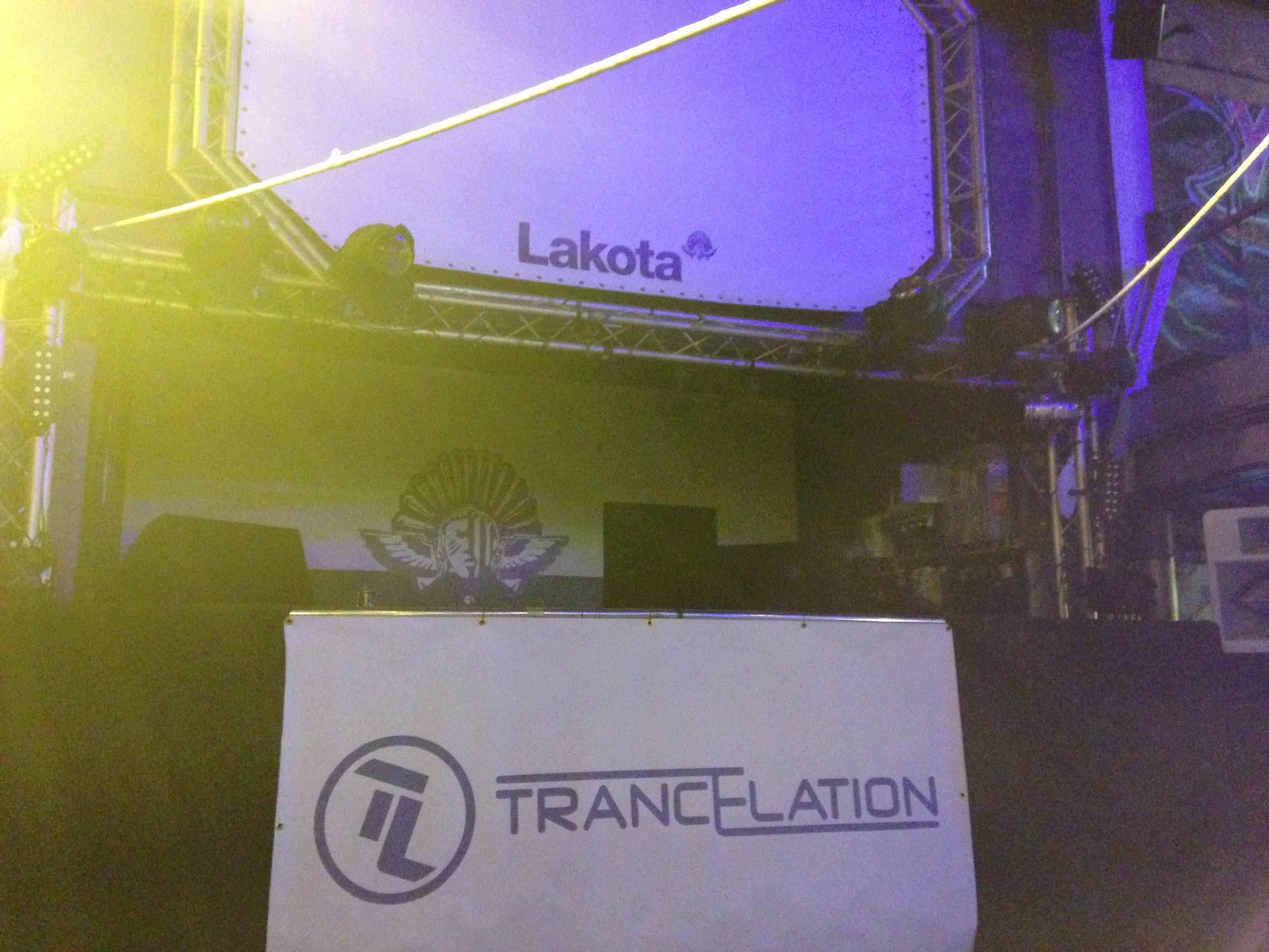 Crowd beneath blue and purple nightclub lasers
